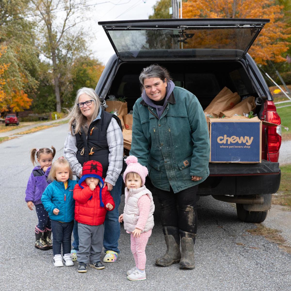 Laura Butler, the kids she cares for and teaches at her home-based childcare program, and farmer Christine Bourque of Blue Heron Farm on CSA drop-off day. Laura Butler, the kids she cares for and teaches at her home-based childcare program, and farmer Christine Bourque of Blue Heron Farm on CSA drop-off day.