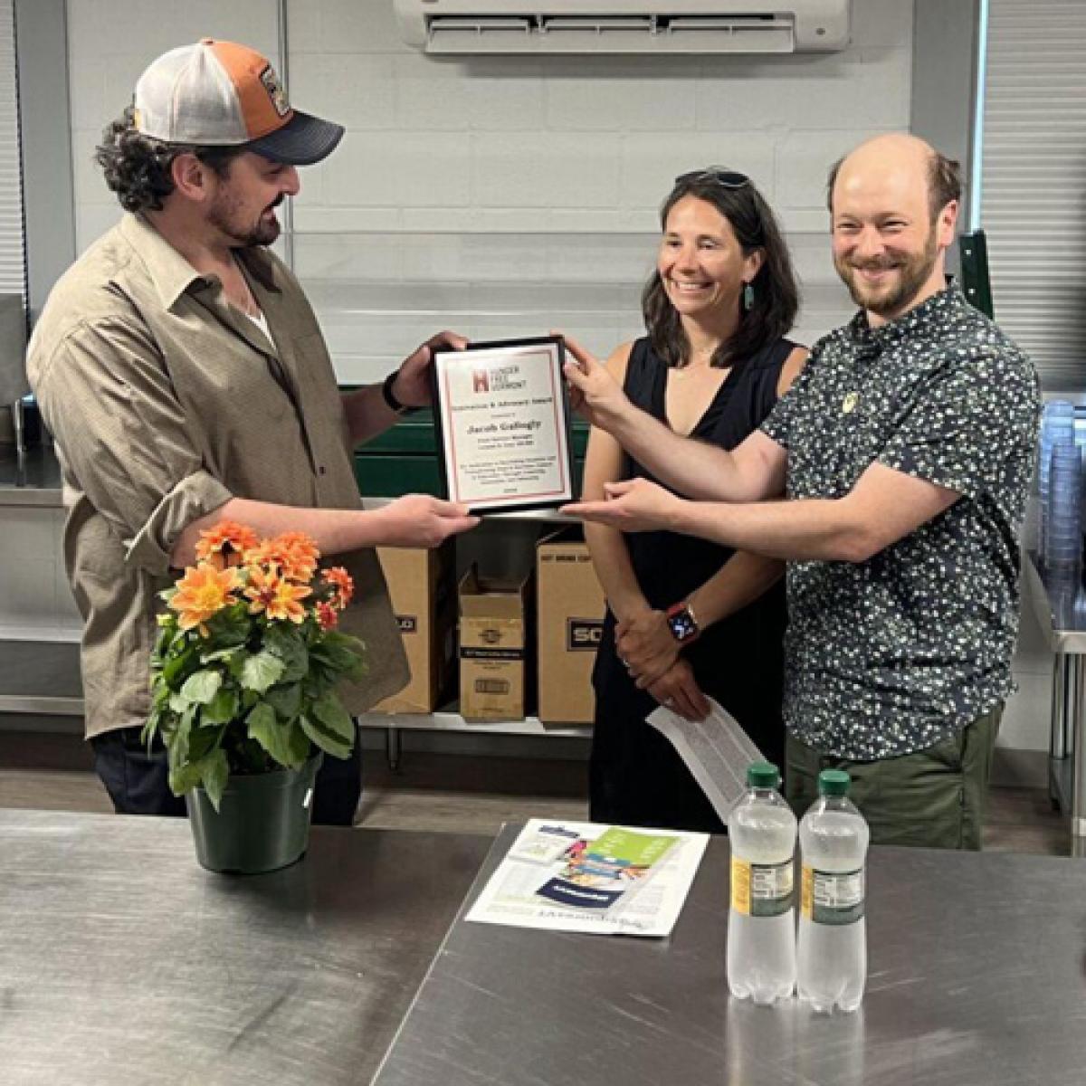 a group of people holding a certificate a group of people holding a certificate